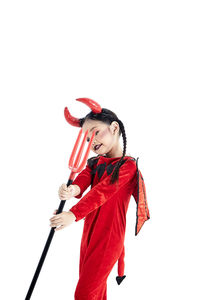 Woman holding red umbrella against white background