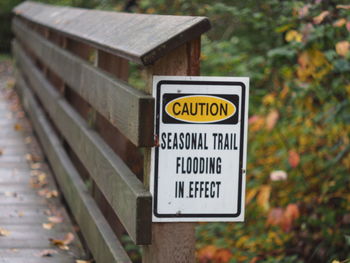 Close-up of warning sign on wood