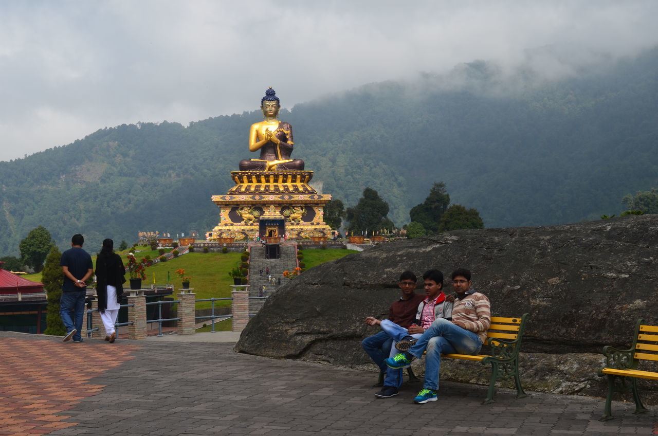 lifestyles, leisure activity, men, tourism, famous place, sky, person, tourist, mountain, travel, travel destinations, built structure, architecture, history, religion, place of worship, international landmark, cloud - sky, rear view