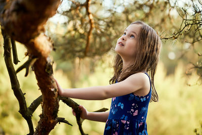 Close-up of girl standing by tree