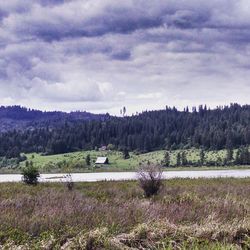 Scenic view of landscape against cloudy sky