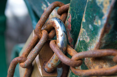 Close-up of rusty chain and padlock on gate