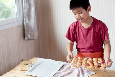 Boy making cookies at home