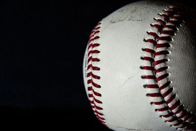 Close-up of ball on table against black background