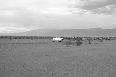 Scenic view of land and mountains against sky