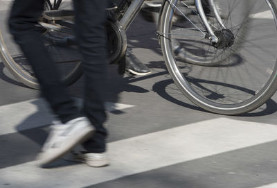 Low section of people riding bicycle on street