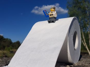 Close-up of toy car on land against sky