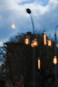 Low angle view of illuminated lights against sky at night
