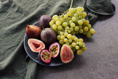 Platter of fresh figs passion fruit and grapes