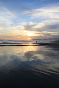 Scenic view of beach against sky during sunset