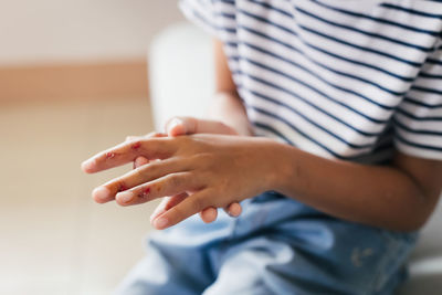 Fresh wound and blood from injured on child fingers after she has been an accident.