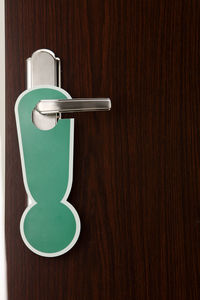 Close-up of exclamation sign on doorknob