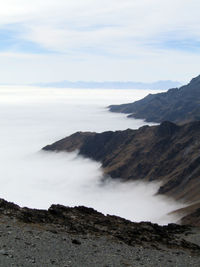 Scenic view of sea and mountains against sky