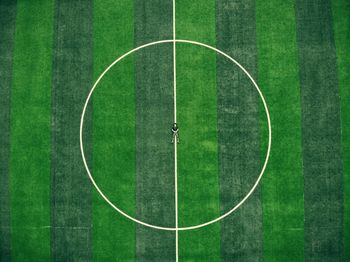 High angle view of man lying on soccer field