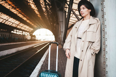 Woman standing on railroad station platform