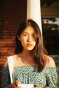 Portrait of beautiful young woman standing outdoors