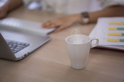 Close-up of coffee cup on table