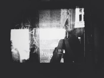 Silhouette of woman against wall