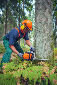 Side view of man working in forest