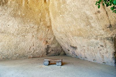 High angle view of cat sleeping on rock