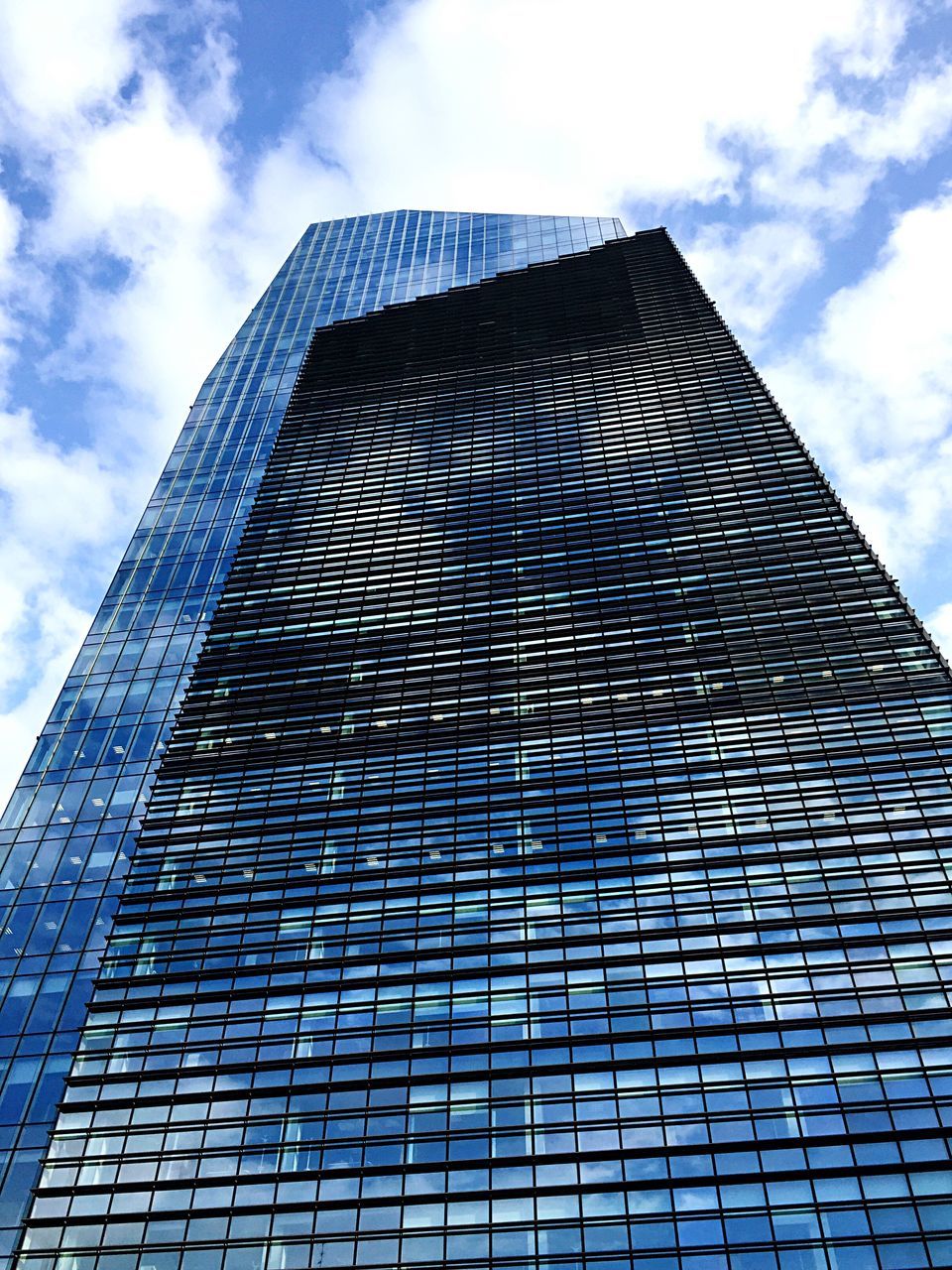 LOW ANGLE VIEW OF BUILDING AGAINST CLOUDS