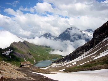 Scenic view of mountains against cloudy sky