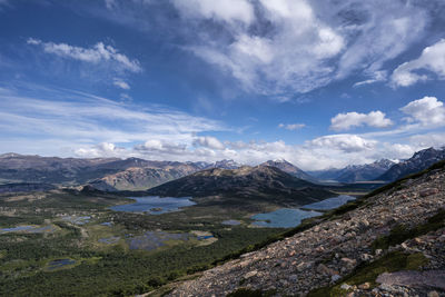 Scenic view of mountains against cloudy sky