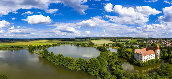 Panoramic view of trees and buildings against sky