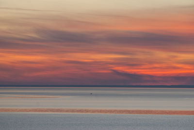Scenic view of sea against romantic sky at sunset