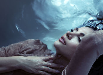 Woman lying down in water