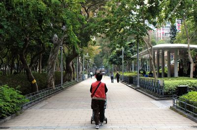 Full length of woman walking on footpath