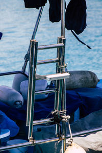 Low section of man holding sailboat in sea