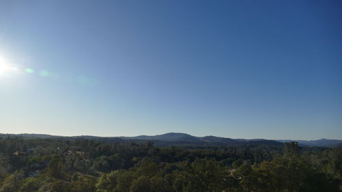 Scenic view of mountains against clear blue sky