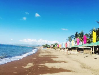 Scenic view of beach against blue sky