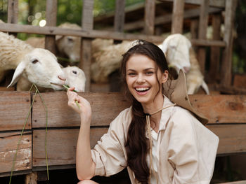 Portrait of young woman with goat