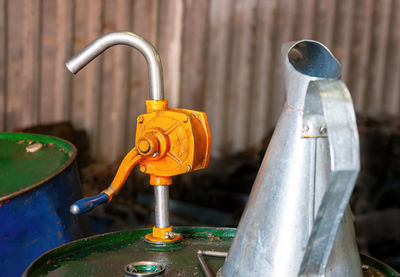 Close-up of water flowing from faucet in container