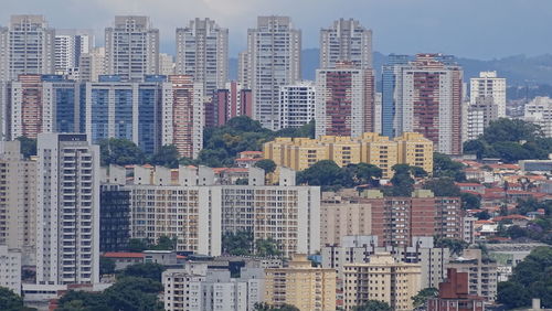 High angle view of buildings in city against sky