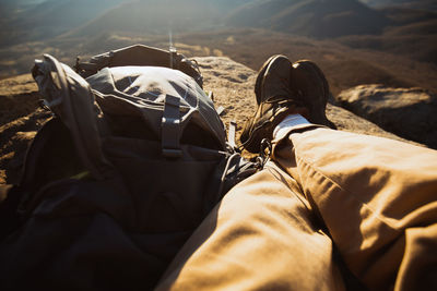 Low section of man relaxing on mountain