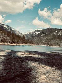 Scenic view of lake against sky during winter