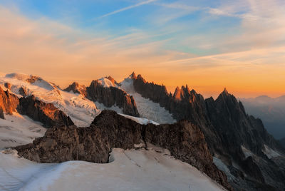 Scenic view of snowcapped mountains against sky during sunset