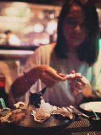 Woman having food in restaurant