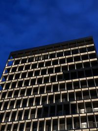 Low angle view of modern building against blue sky
