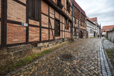 Footpath amidst buildings in city