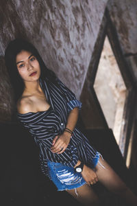 Young woman standing in abandoned building