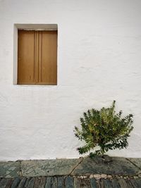 Small window on white wall of building