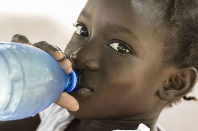 Close-up portrait of boy drinking water