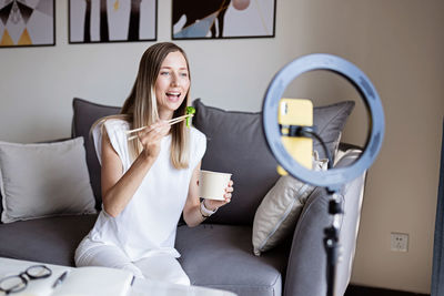 Young woman drinking coffee cup at home