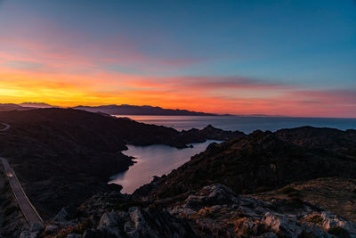 Scenic view of sea against romantic sky at sunset