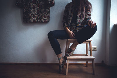 Woman sitting on chair at home