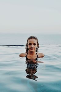 Portrait of boy standing in sea